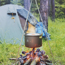 Load image into Gallery viewer, Photo of Tripod Cooking set with pot handing over a campfire and a tent in the background
