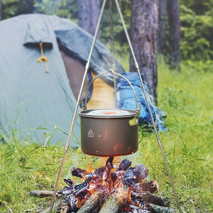 Photo of Tripod Cooking set with pot handing over a campfire and a tent in the background