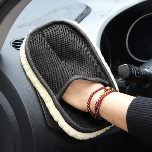 Hand in Glove wiping car dashboard