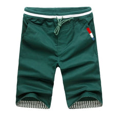 Load image into Gallery viewer, front view of dark green shorts
